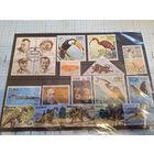 Подборка марок в кляссере: космос, динозавры и пр.