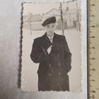 Фотография. Молодой человек с папиросой в пальто в день выборов. 1957 год.   г. Щигры. Ретро СССР.