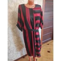 Стильное платье на 64-68 размер, идеальное состояние. Очень хорошо смотрится на фигуре, современно и красиво. Платье прямого фасона, талия регулируется поясом, сзади замок, на подкладке.