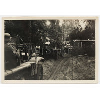 Немецкий солдат с трофейным советским ППШ в кабине тягача в составе колонны. Впереди едет легкий танк